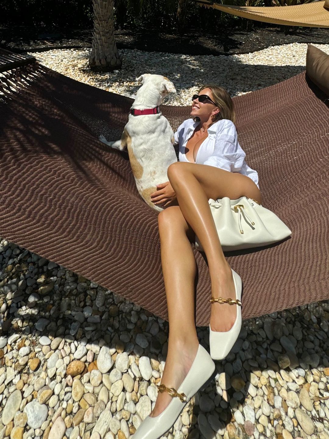 Sydney Sweeney poses on a hammock with her dog