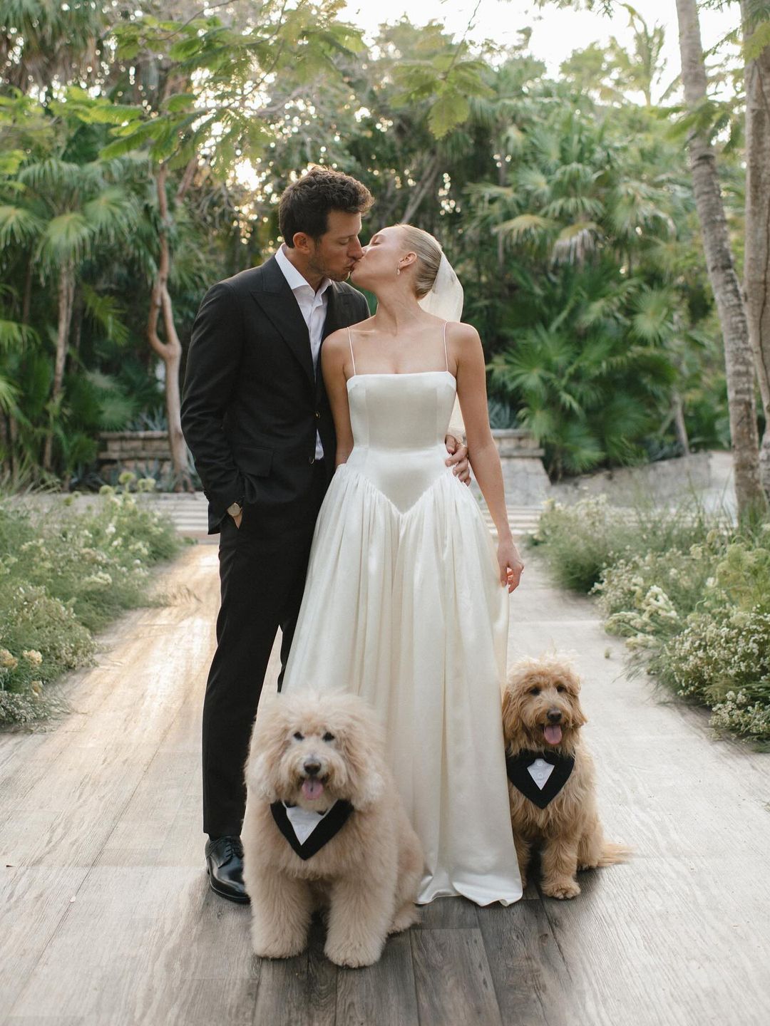  Alex Cooper and Matt Kaplan pose on their wedding day with their dogs