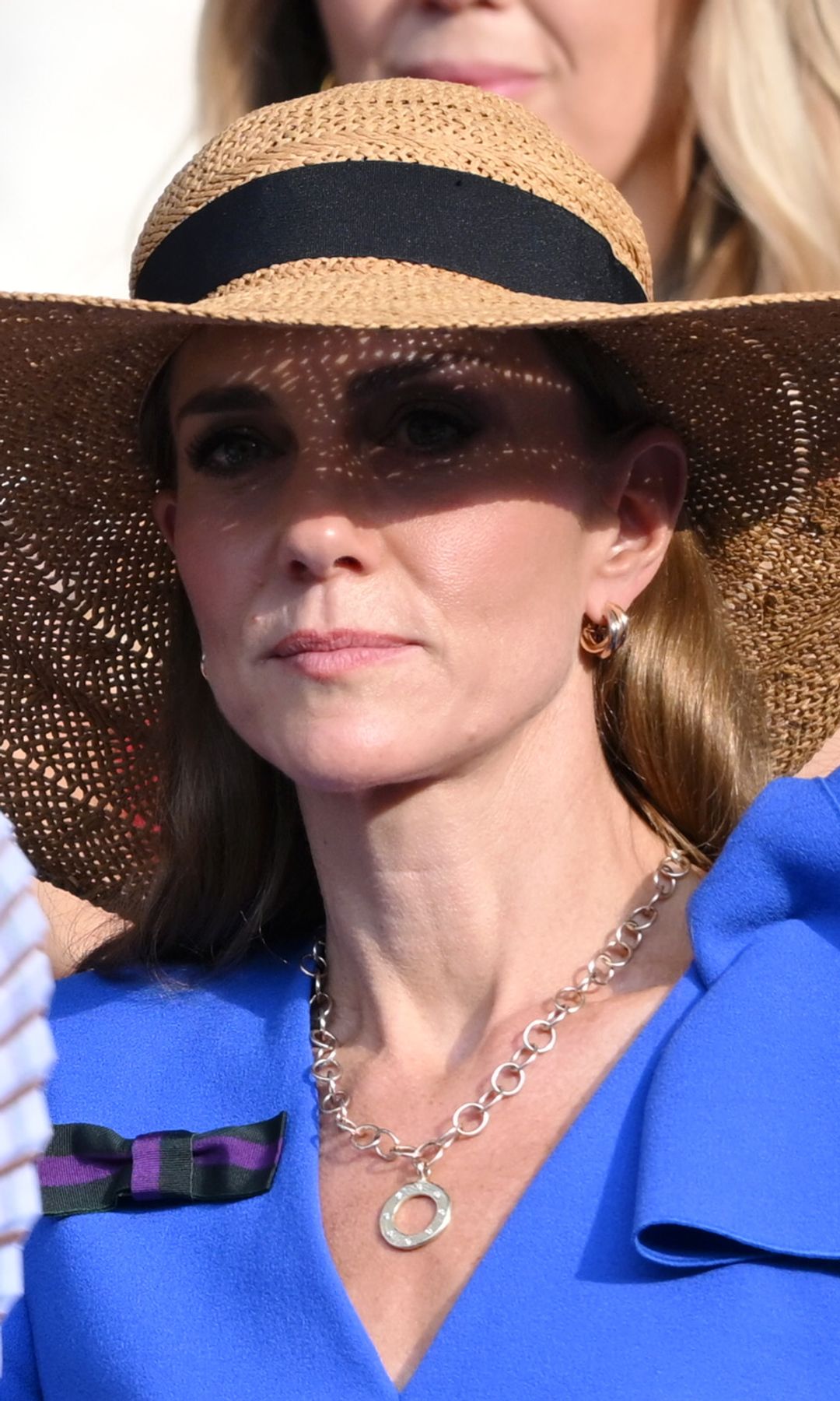 Kate Middleton with a fan in a sunhat