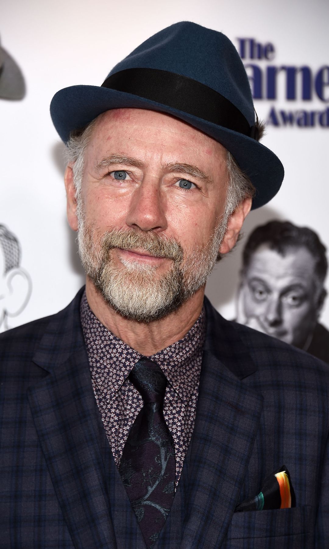 Xander Berkeley in a suit and trilby hat at the Carney Awards