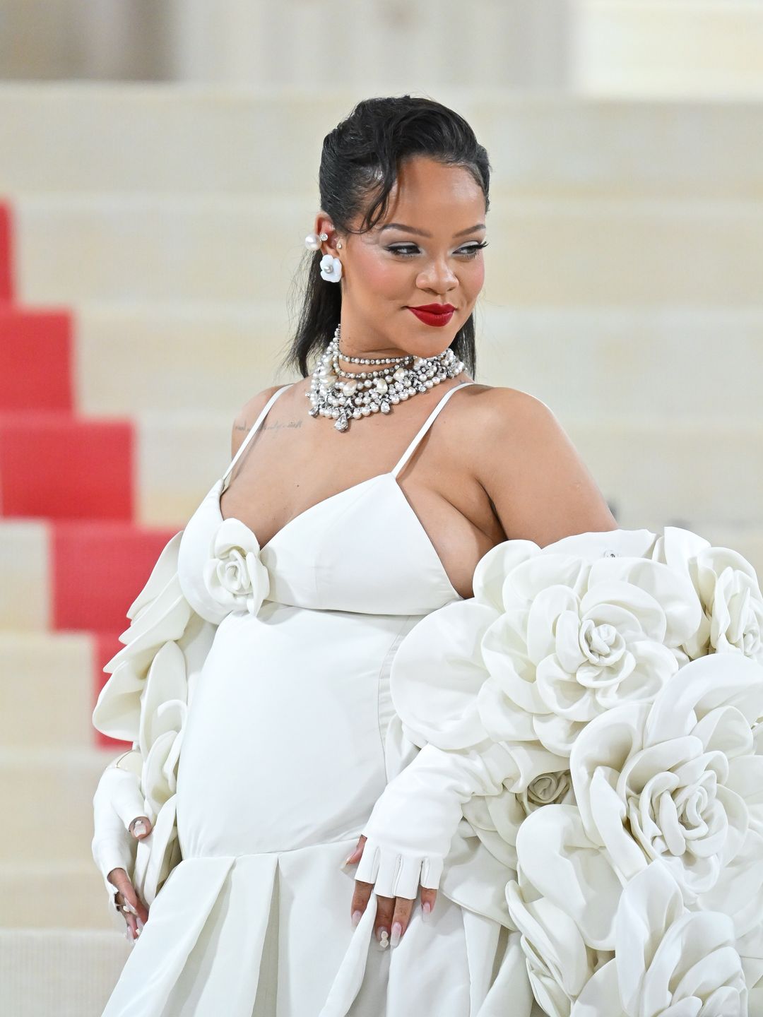 Rhianna attends the Met Gala 2023 wearing a white gown and a platinum necklace from Bulgari