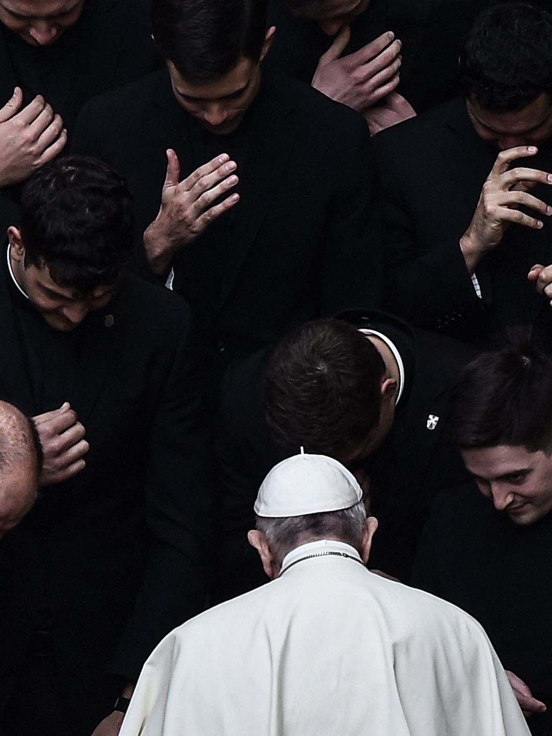 Pope Francis prays with priests in The Vatican.