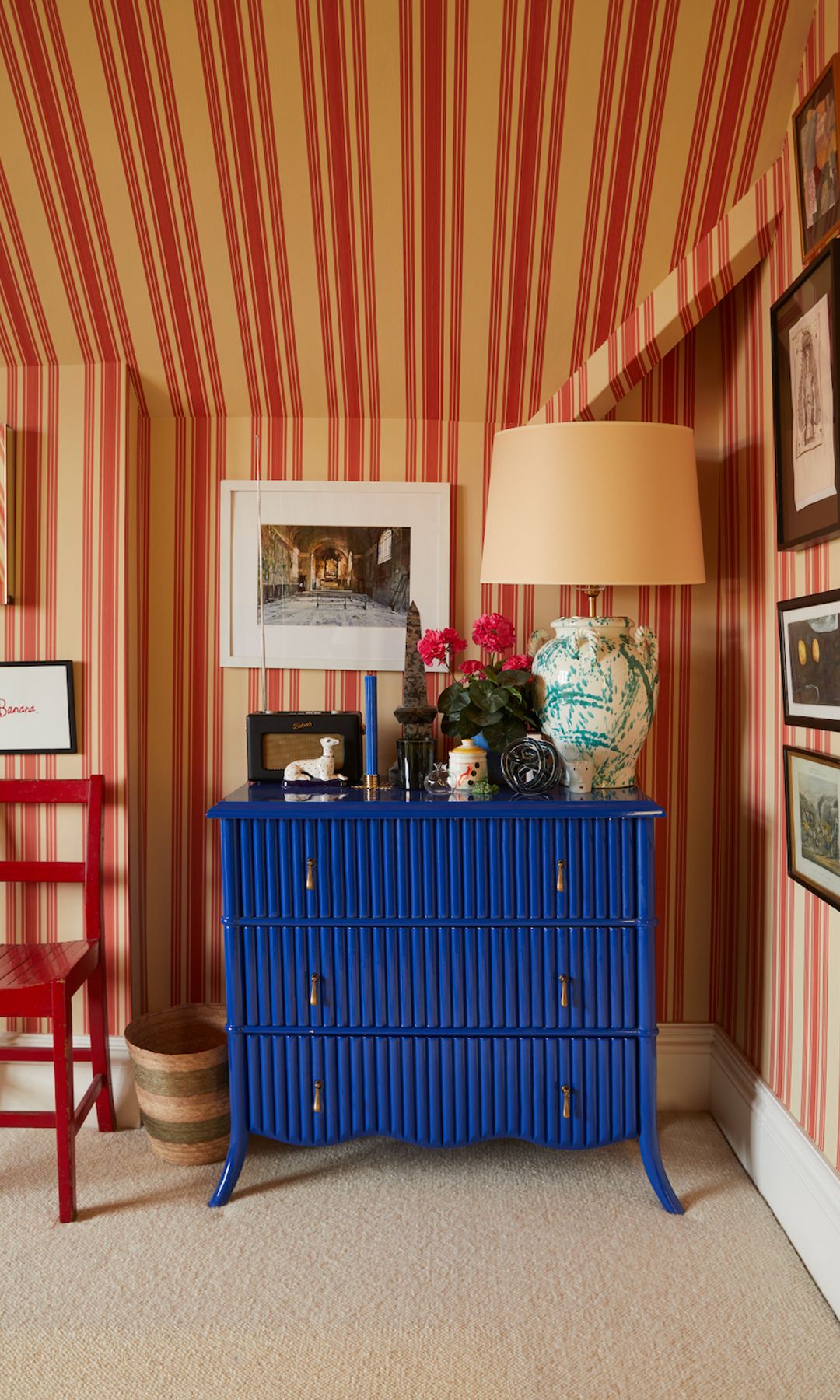 An ornate lamp and eyecatching ceramics add further interest to a striking chest of drawers