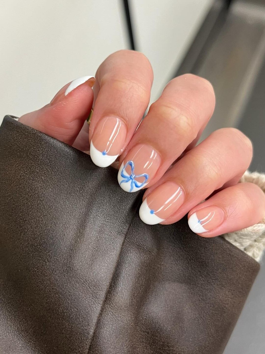 French tipped manicure with hand painted blue bows