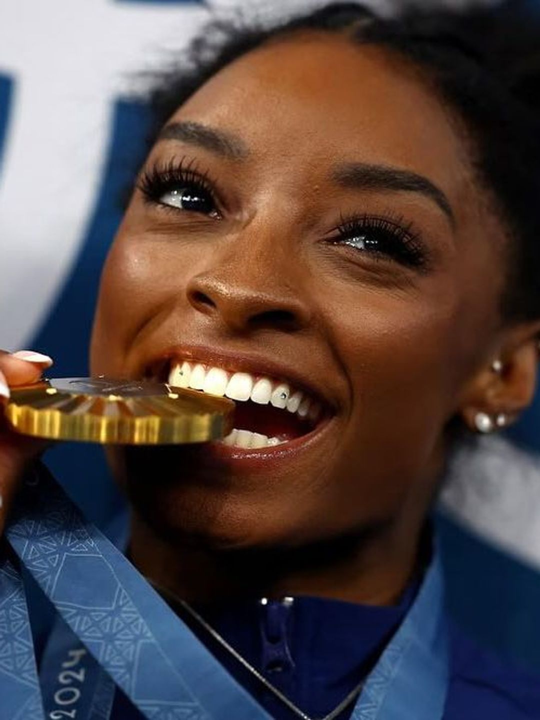 Simone Biles shows off her tooth gems at the Olympics