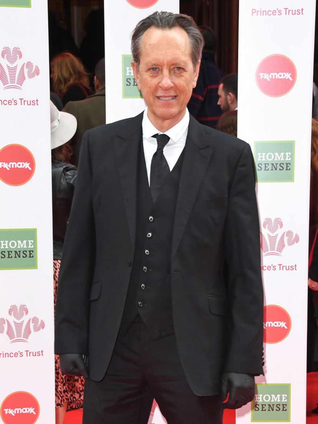 Richard E. Grant wearing a black suit in 2020. 
