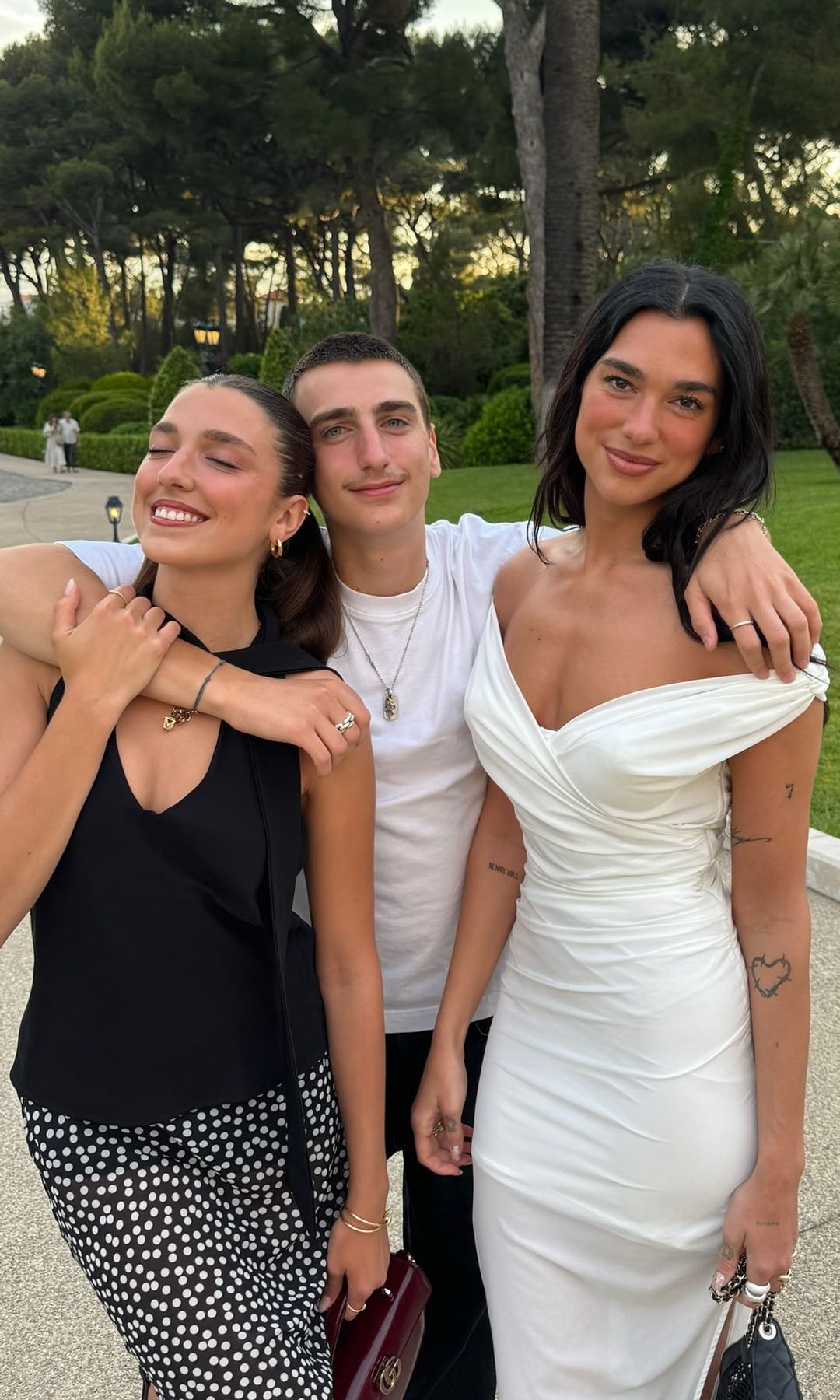 Dua, Rina and Gjin Lipa pose for a family picture on the beach