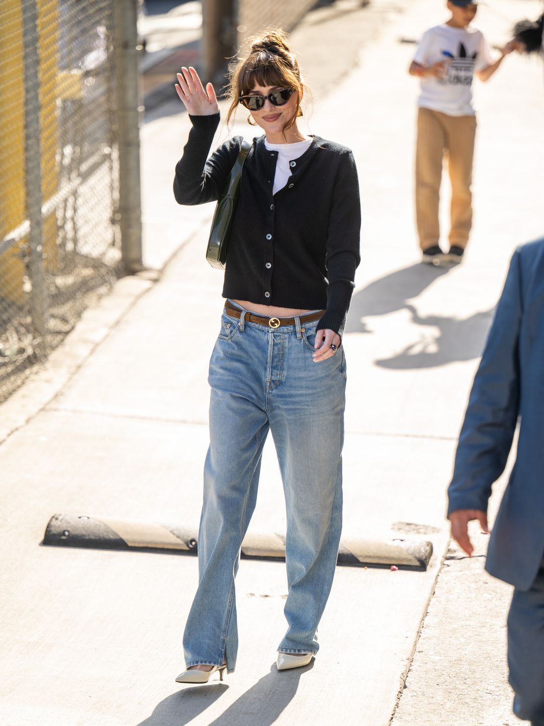 Dakota Johnson is seen at "Jimmy Kimmel Live!" on June 19, 2024 in Los Angeles, California wearing jeans, a black cardigan and heels