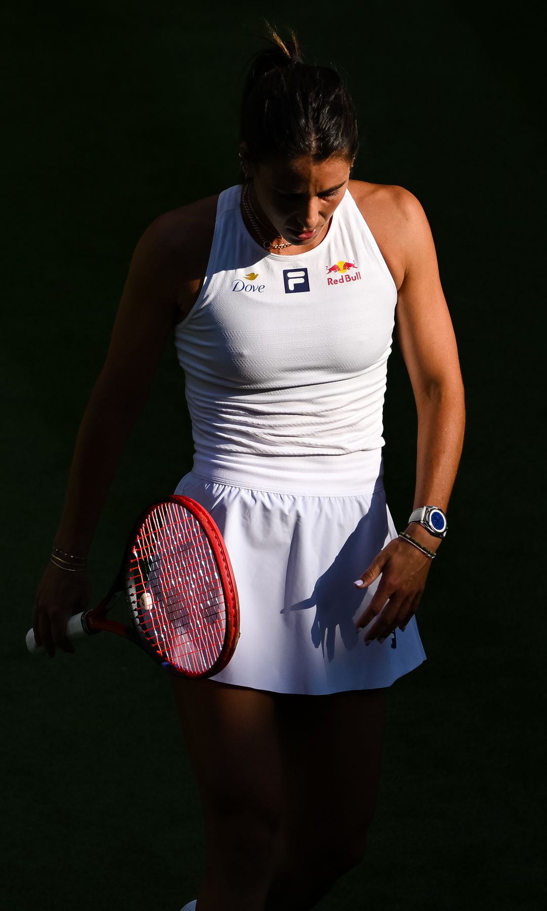 Emma Navarro  in tennis whites looking dowm