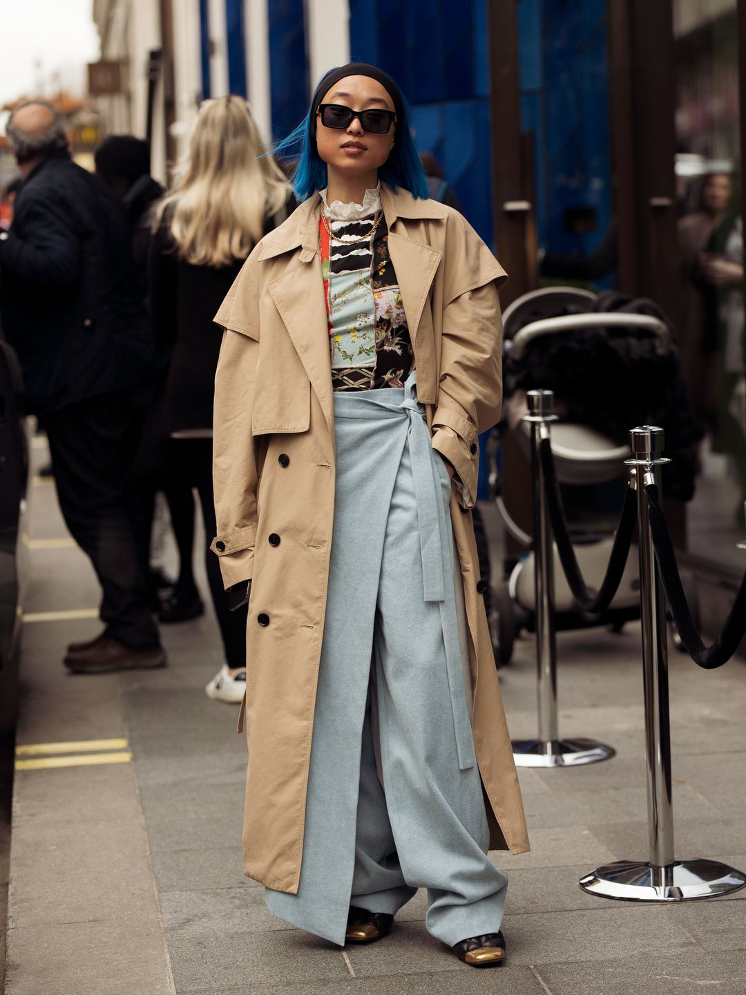 Woman wearing a trench coat with a long skort 