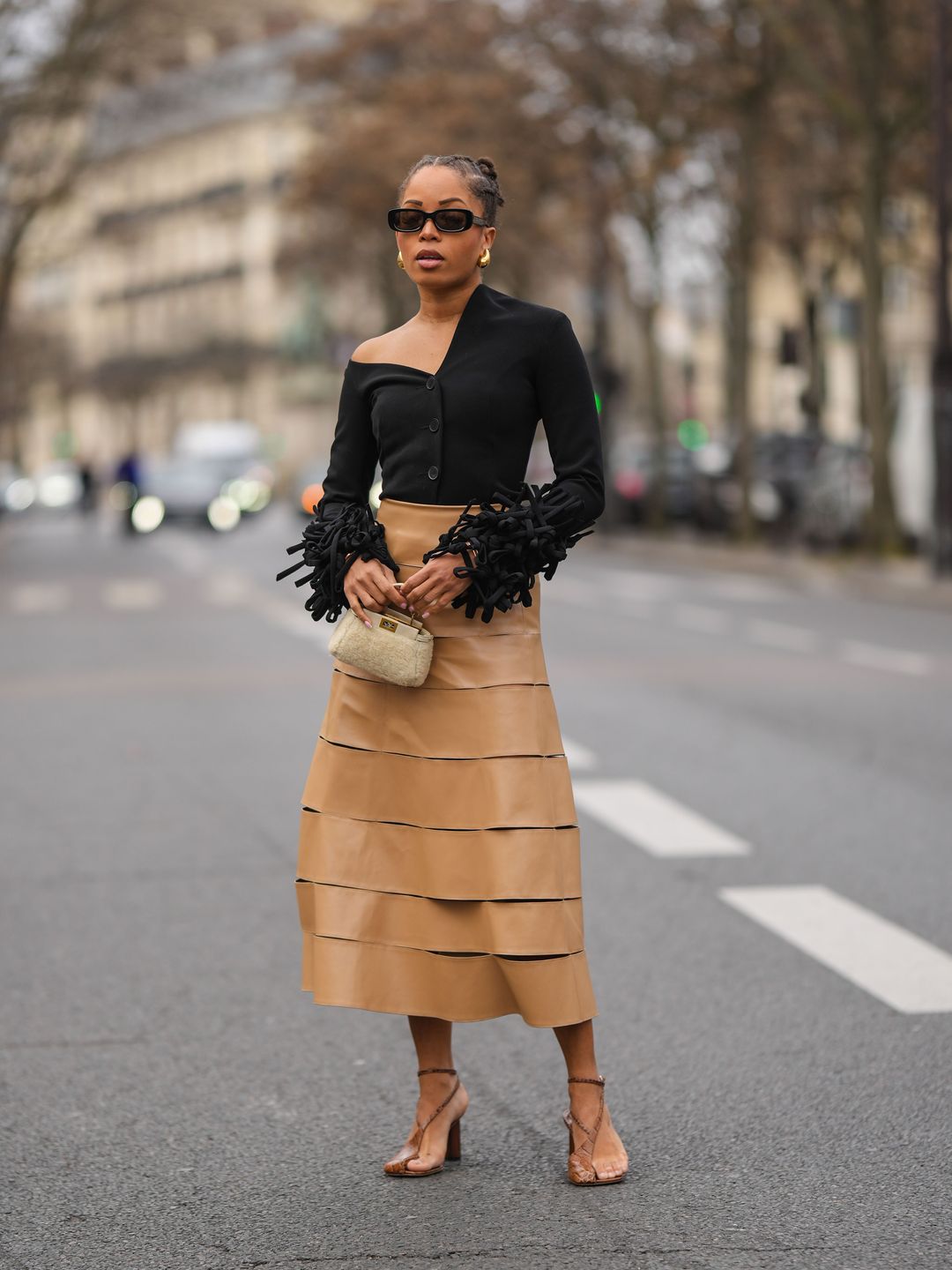 Ellie Delphine wears statement sleeve top and camel skirt 