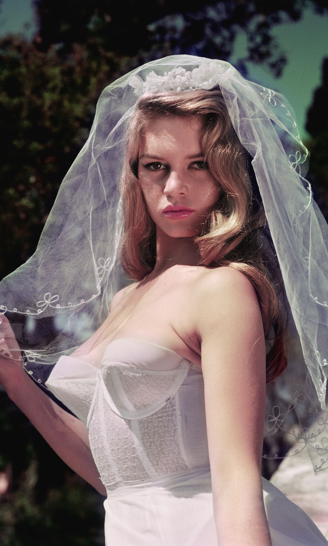Brigitte Bardot wears a cone bra corset dress and wedding veil