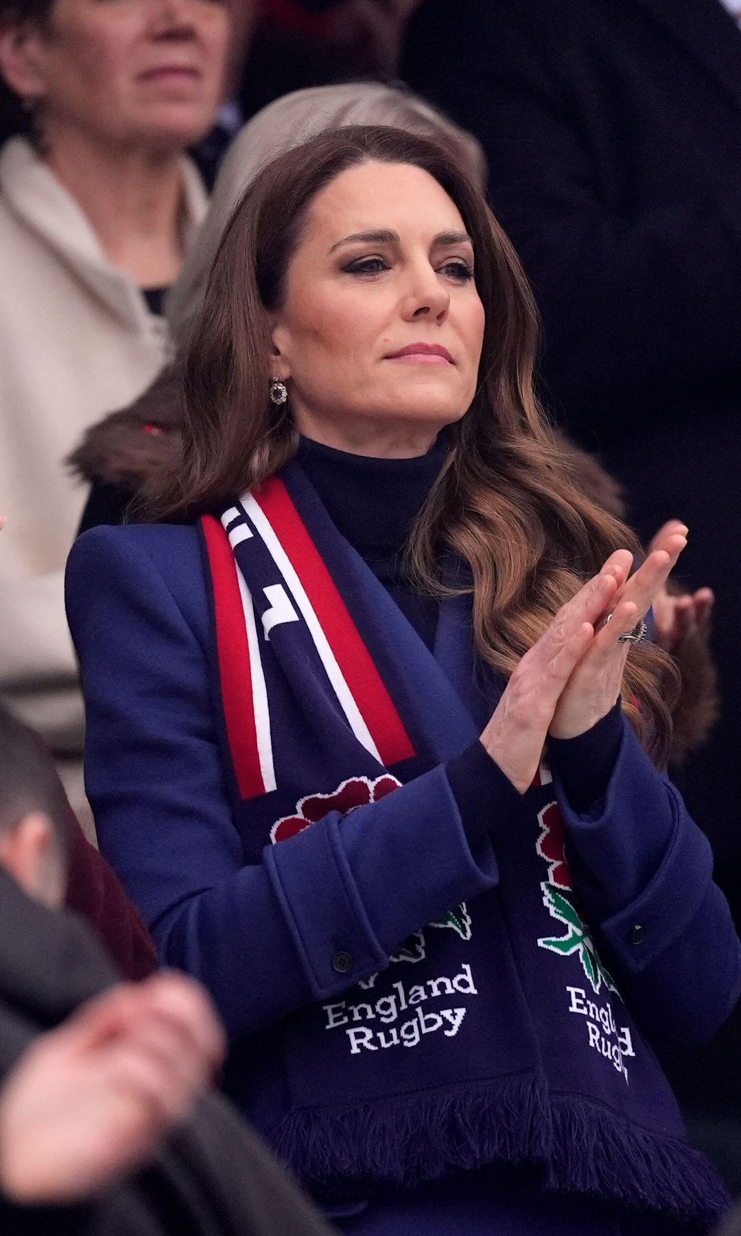 Kate Middleton applauding while looking unhappy