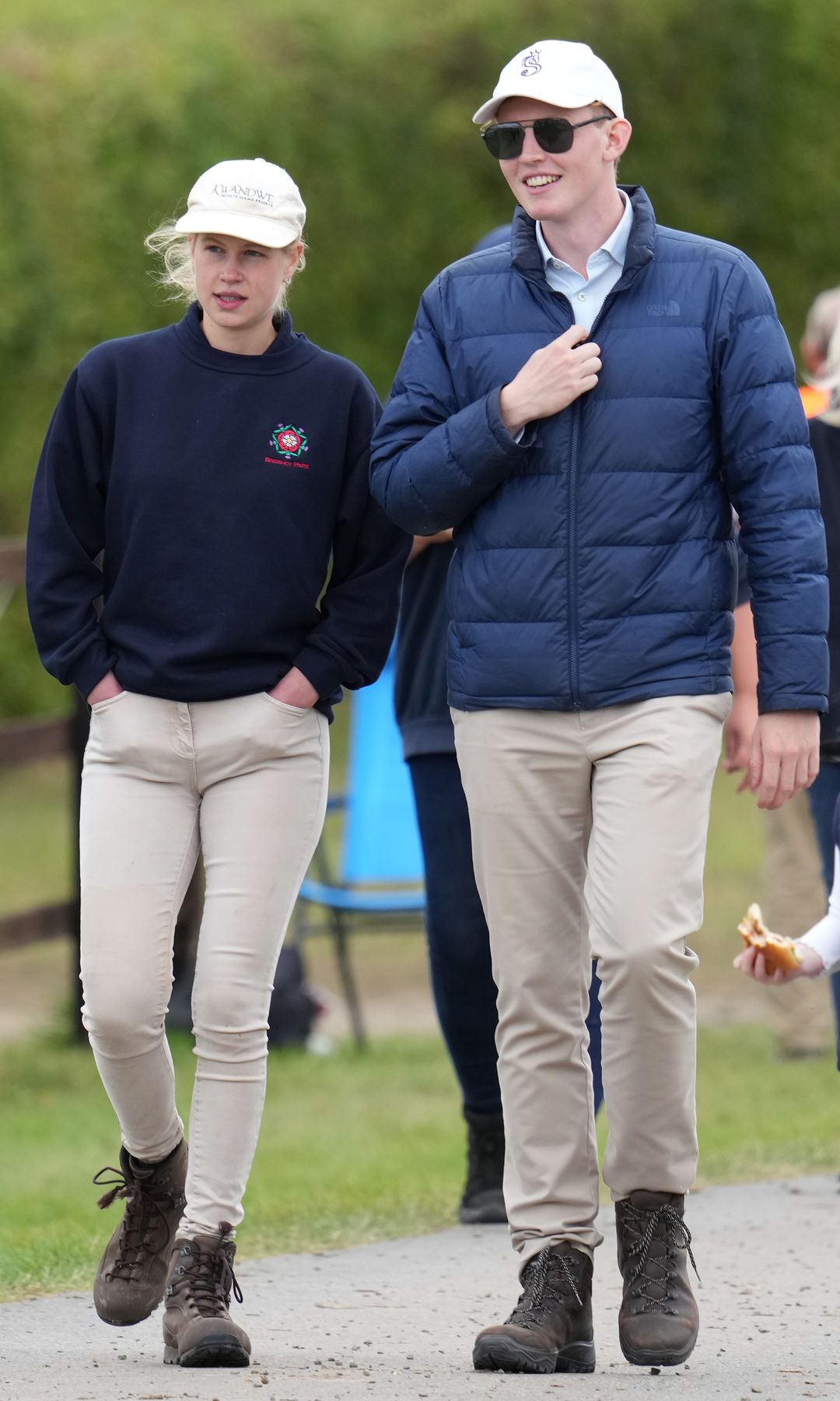 Lady Lousie Windsor with her hands in her pockets walking with Felix da Silva-Clamp