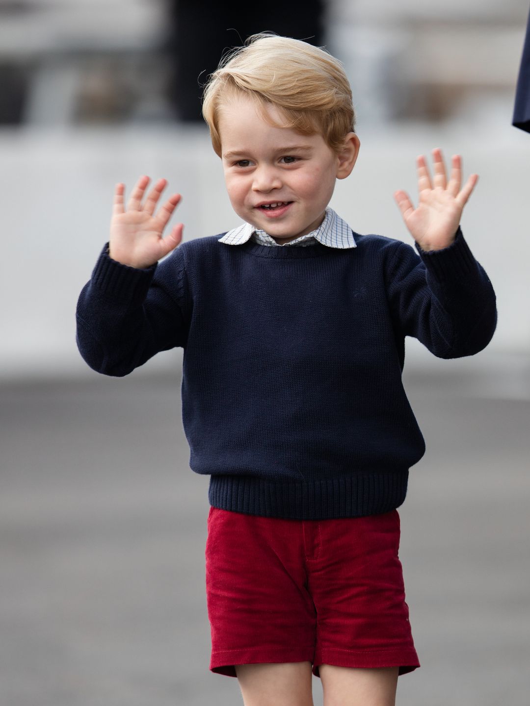 little boy waving and smiling