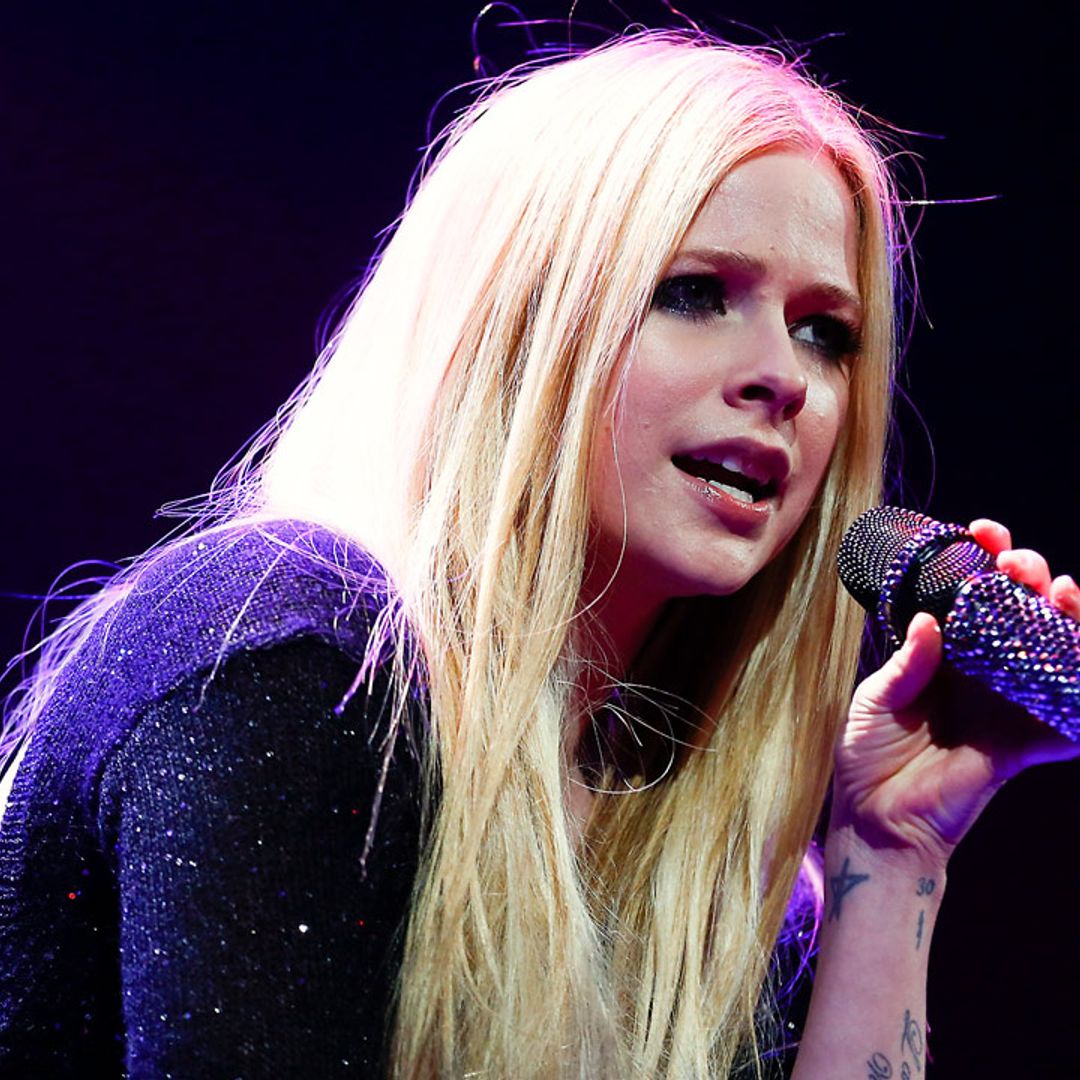 Avril Lavigne poses in thigh-high boots and bralette as she shares new heartbreak