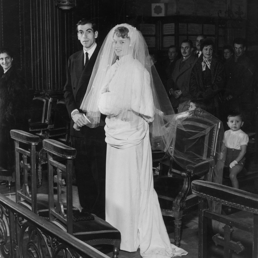 12th December 1952:  Full-length portrait of French actor Brigitte Bardot and her husband, French director Roger Vadim (1928-2000), standing at the altar during their wedding ceremony at the Church of Passy, Paris