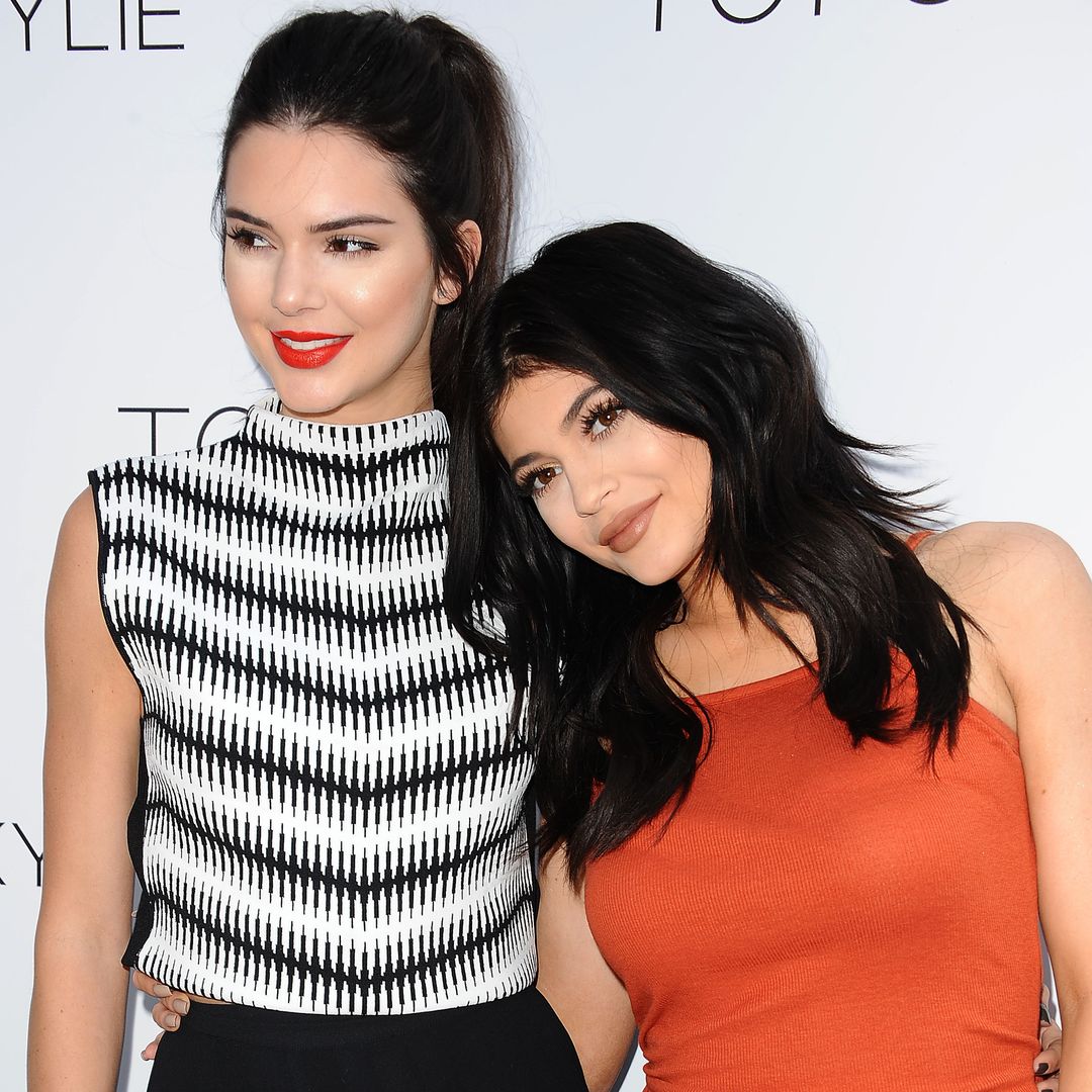 Kylie and Kendall smiling at their Topshop launch