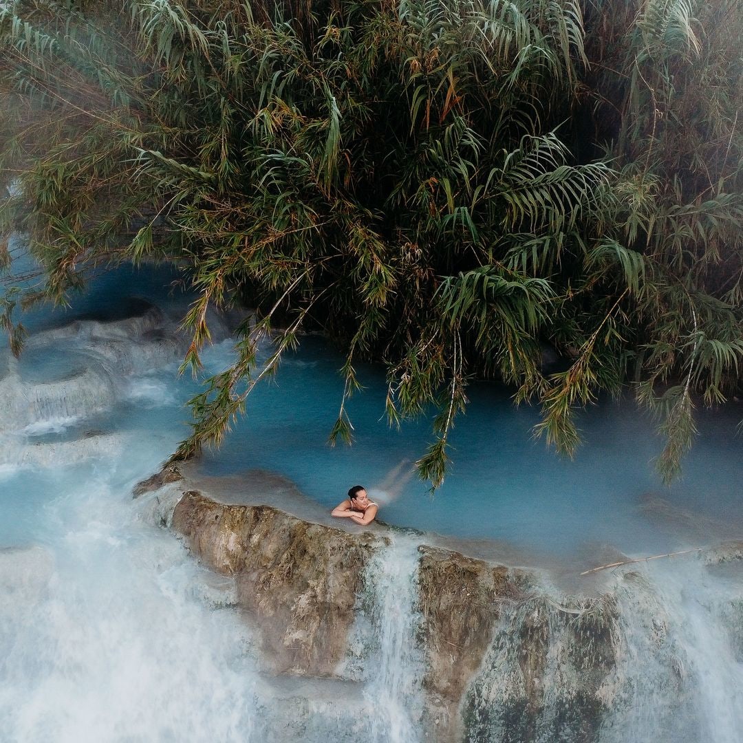 A woman at the Cascate del Mulino hot springs