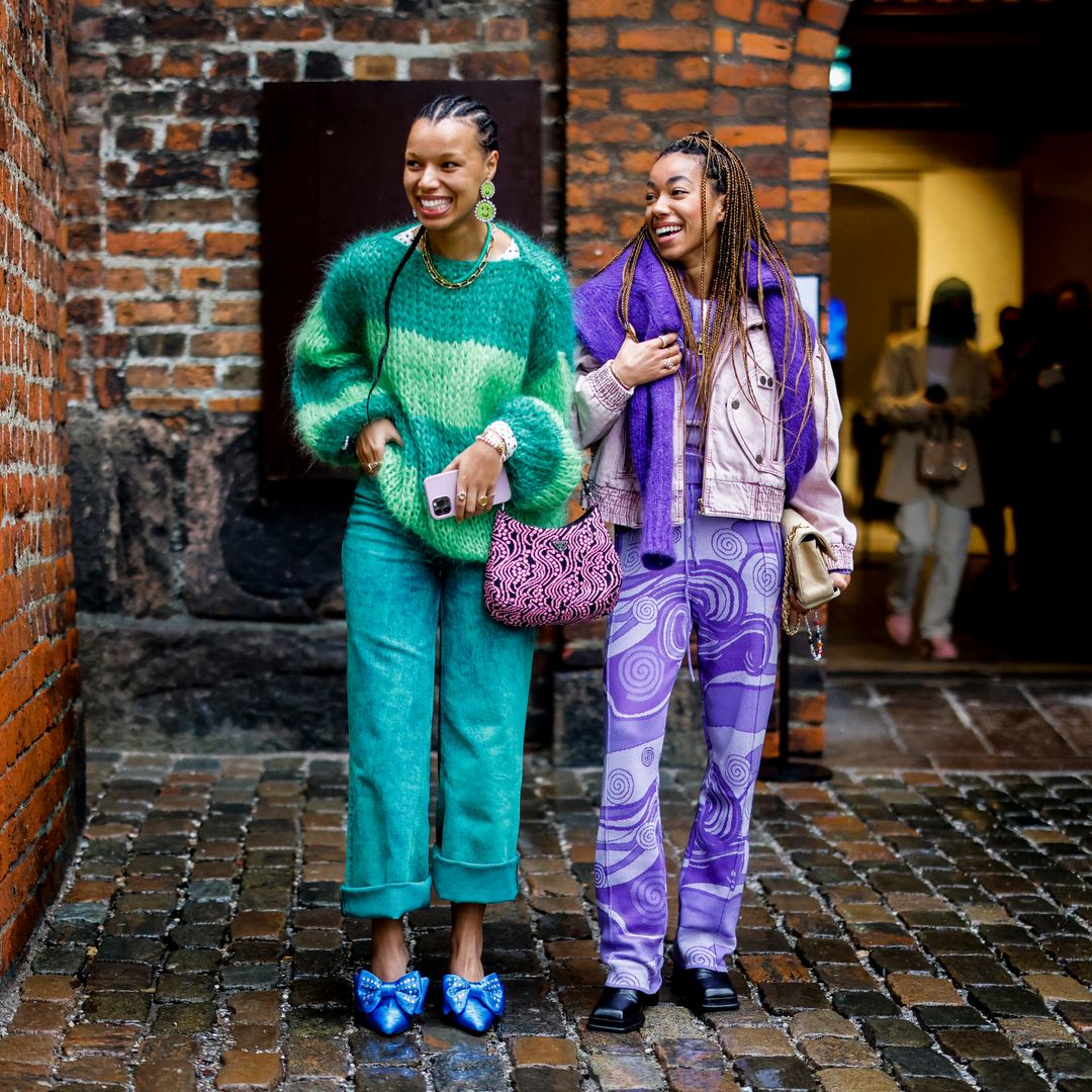Fashion week guests wearing vivid colours outside a show 