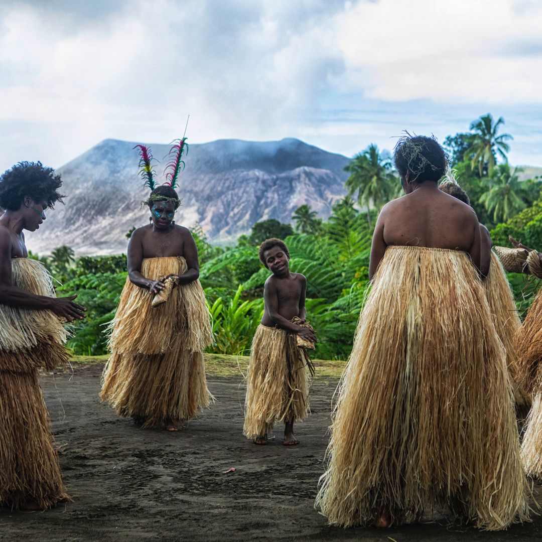 tradition dancers in Vanuatu with mountain in background