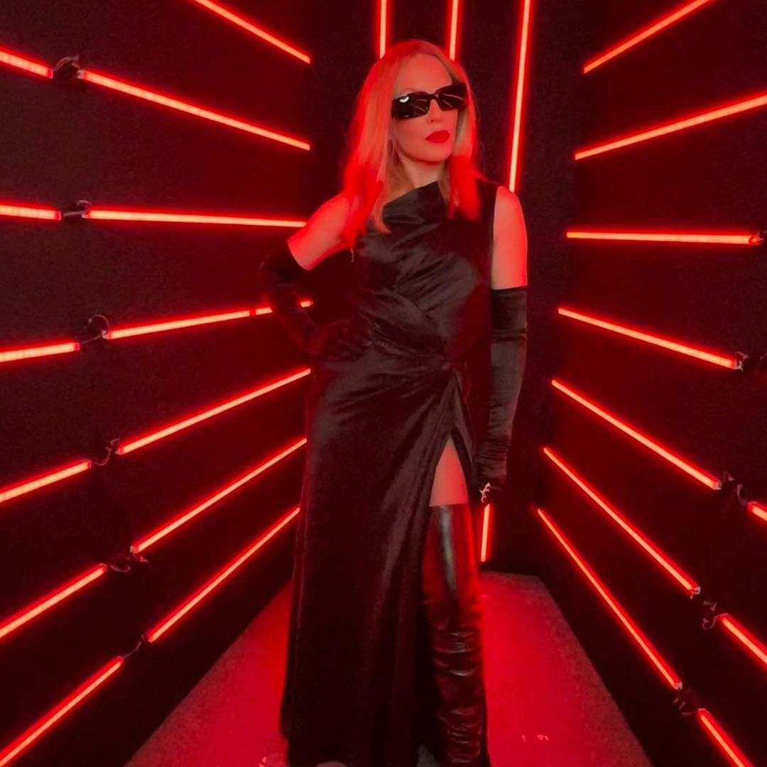 Kylie Minogue stuns in high-slit dress and leather boots as she debuts new red hair