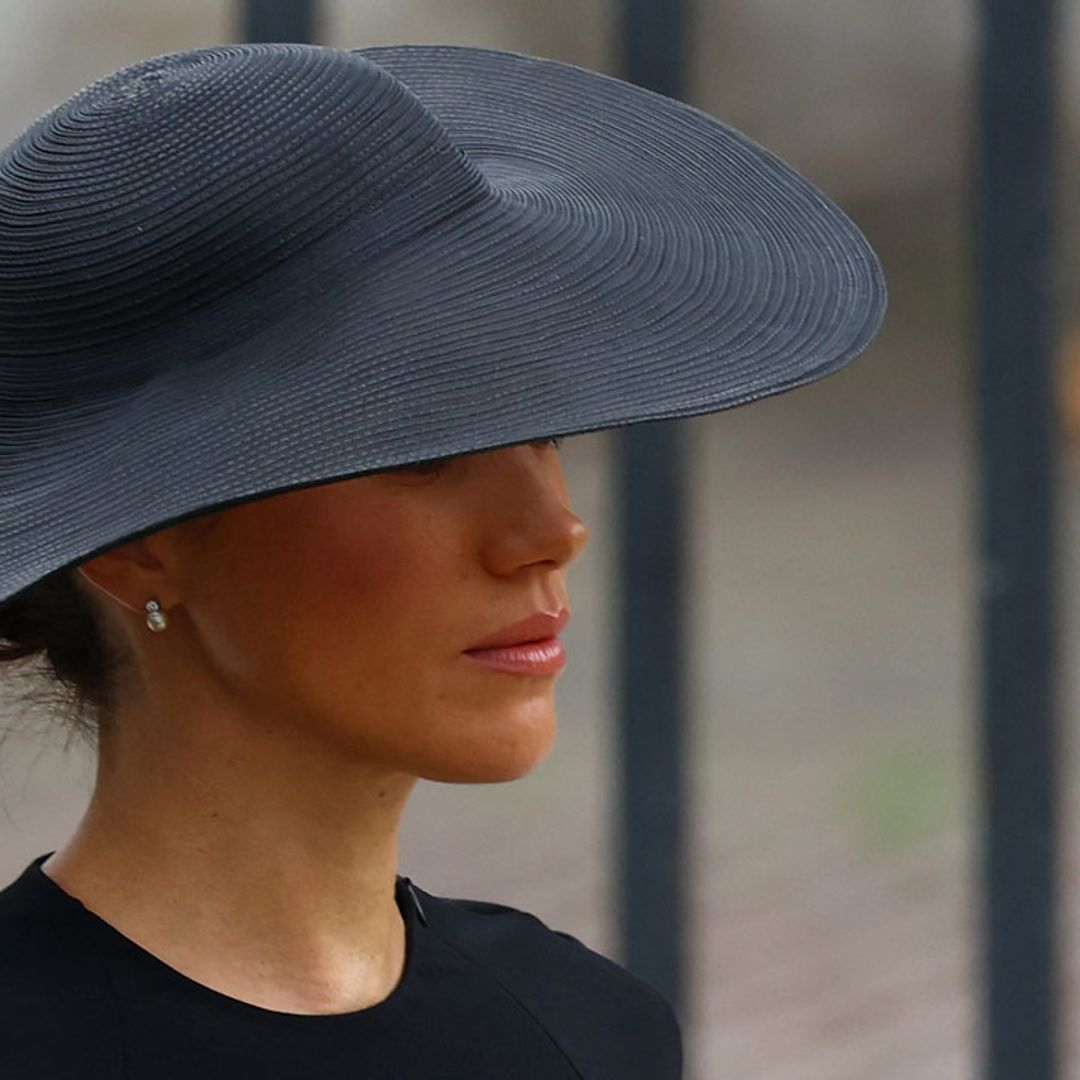 Duchess Meghan looks refined in wide-brimmed Hepburn hat and heavy makeup for the Queen's funeral