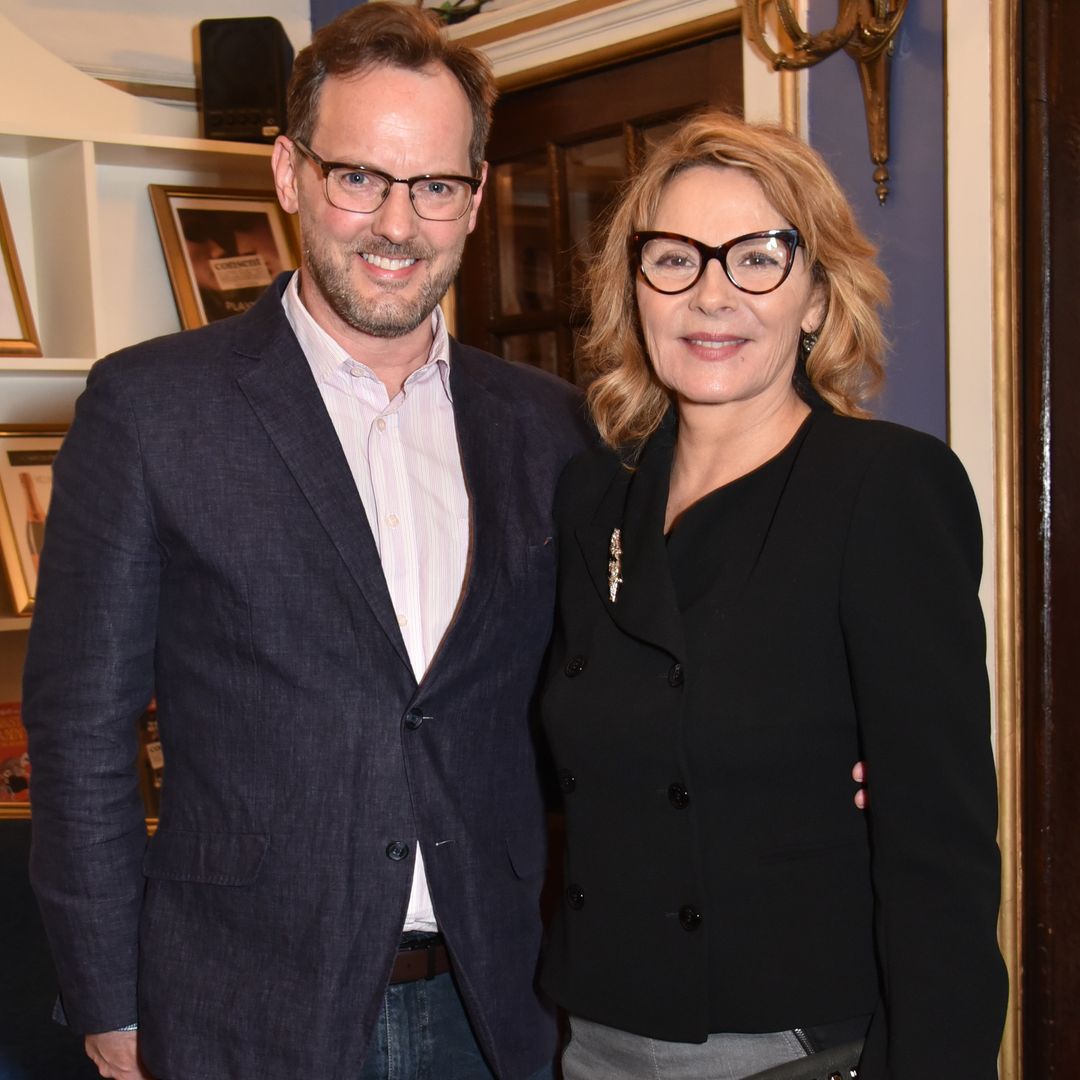 Russell Thomas and Kim Cattrall standing smiling for a photo