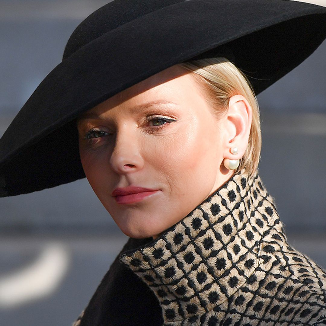 Princess Charlene is a gothic vision in lace veil for poignant outing