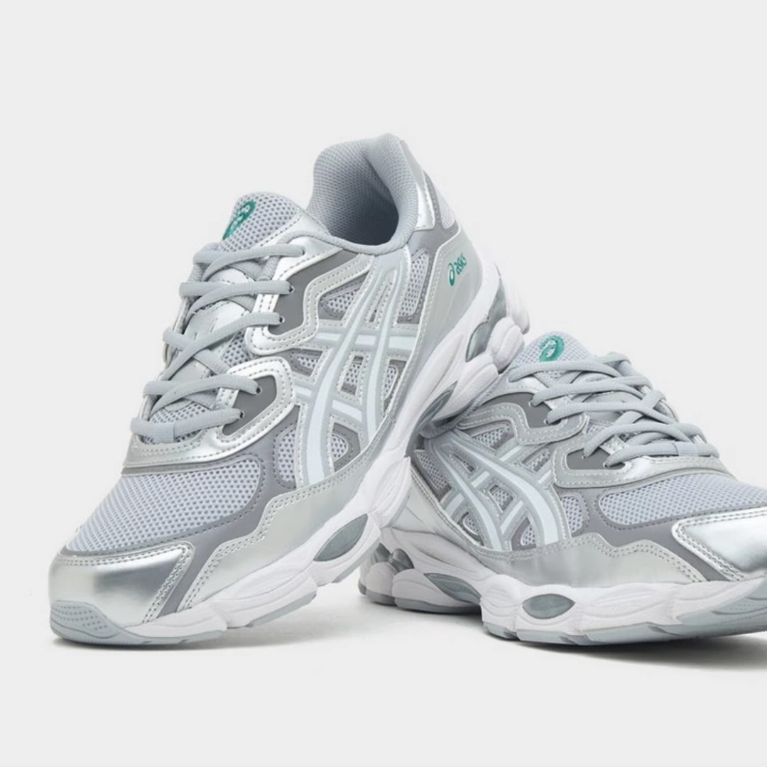 A close-up image of a pair of grey ASICS' GEL-NYC sneakers resting on each other 