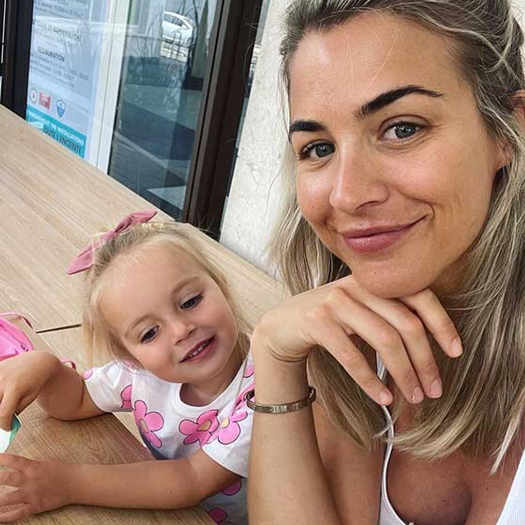 Gemma Atkinson's daughter Mia giggles as she chases dad Gorka around family garden
