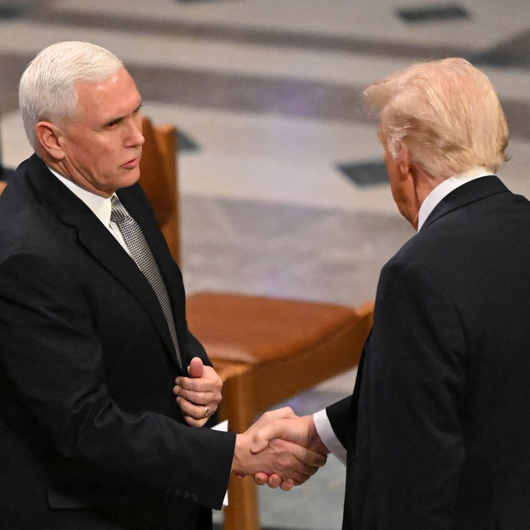 Former US Vice President Mike Pence (L) shakes hands with President-elect Donald Trump before a State Funeral Service for former US President Jimmy Carter at the Washington National Cathedral in Washington, DC, on January 9, 2025