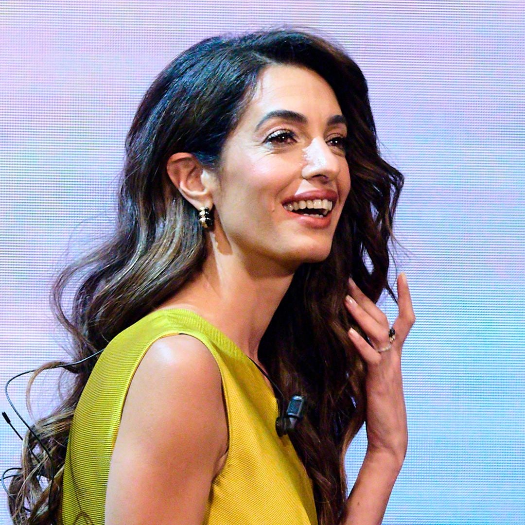 Amal Clooney wows in a slinky green dress as she steps out with husband George