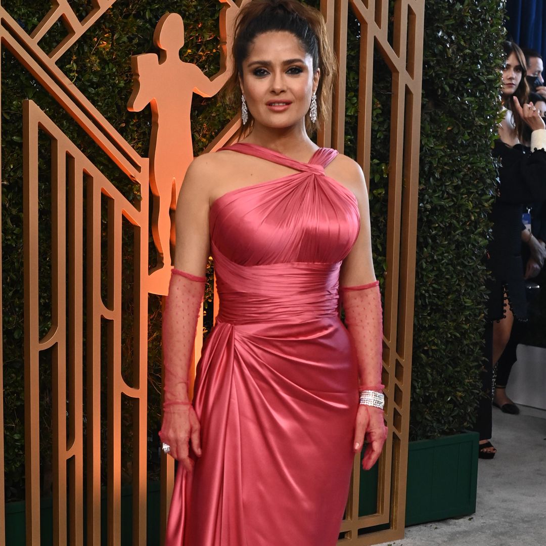 Salma Hayek stuns in hot pink bikini and windswept beach curls