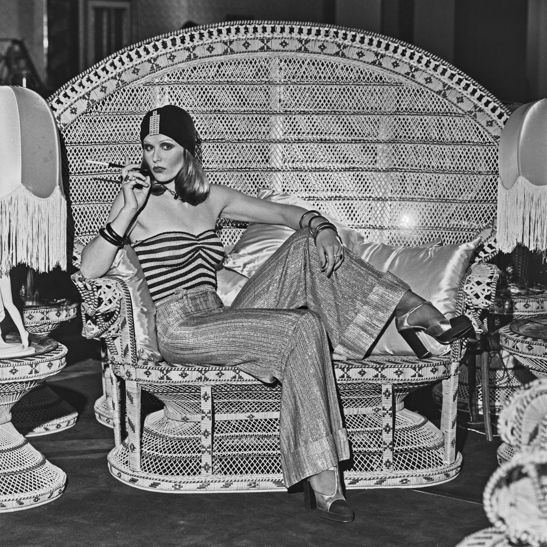 A model wearing wide-legged trousers, a striped tube top and a turban-style hat at the Biba boutique in London, UK, 6th September 1973.  