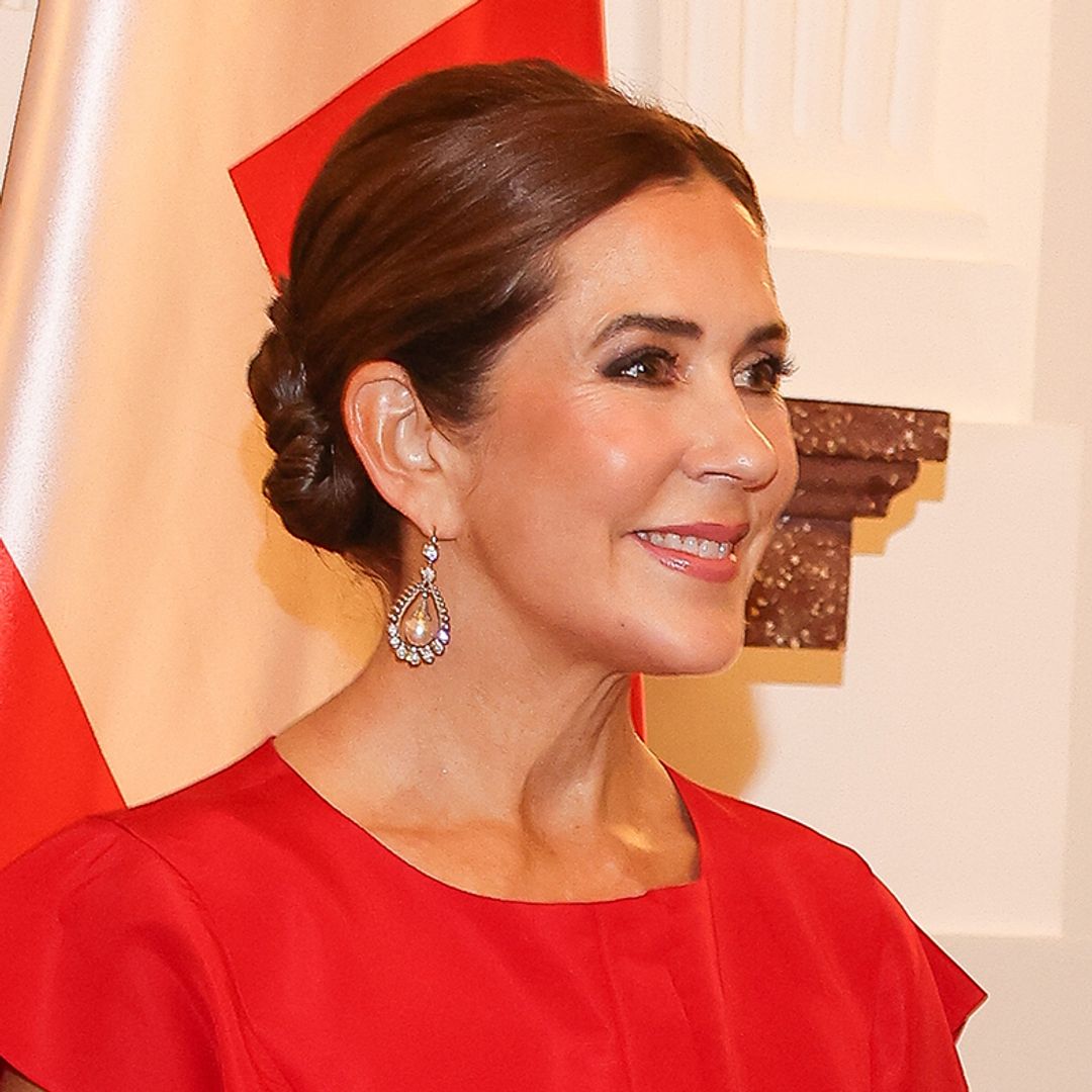 Queen Mary of Denmark is a satin dream in royal red ballgown