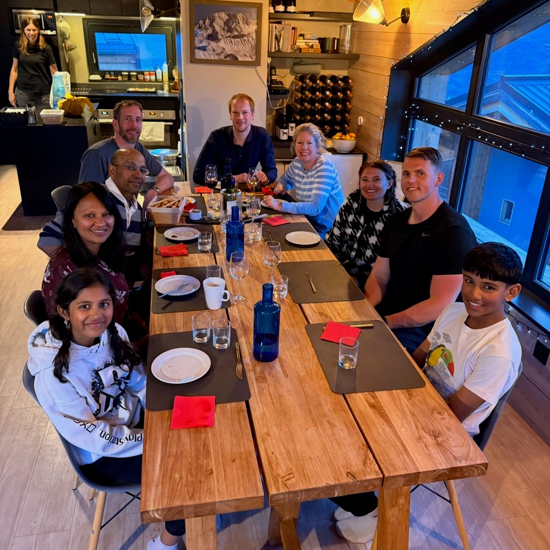 People sitting around a dining table in a ski chalet