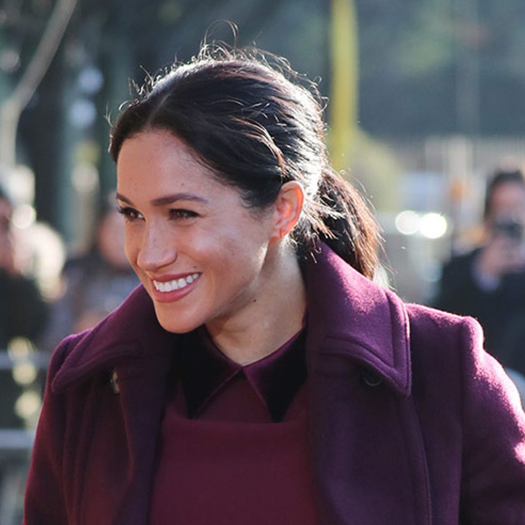 Meghan looks magnificent in maroon as she revisits the Hubb Kitchen
