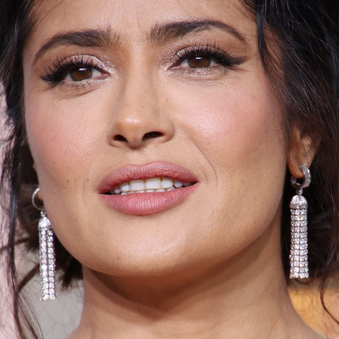 Salma Hayek turns heads in fishnets and leather dress with a twist
