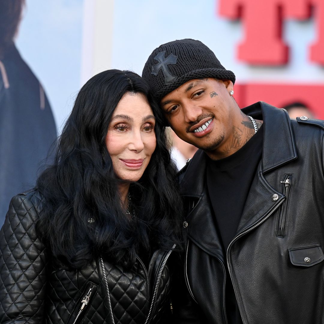 Cher and Alexander Edwards look utterly loved up as they match in black biker leather for red carpet appearance
