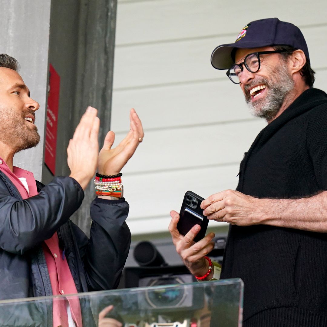 Hugh Jackman shakes off the divorce blues as he tags along with Ryan Reynolds to MetLife Stadium