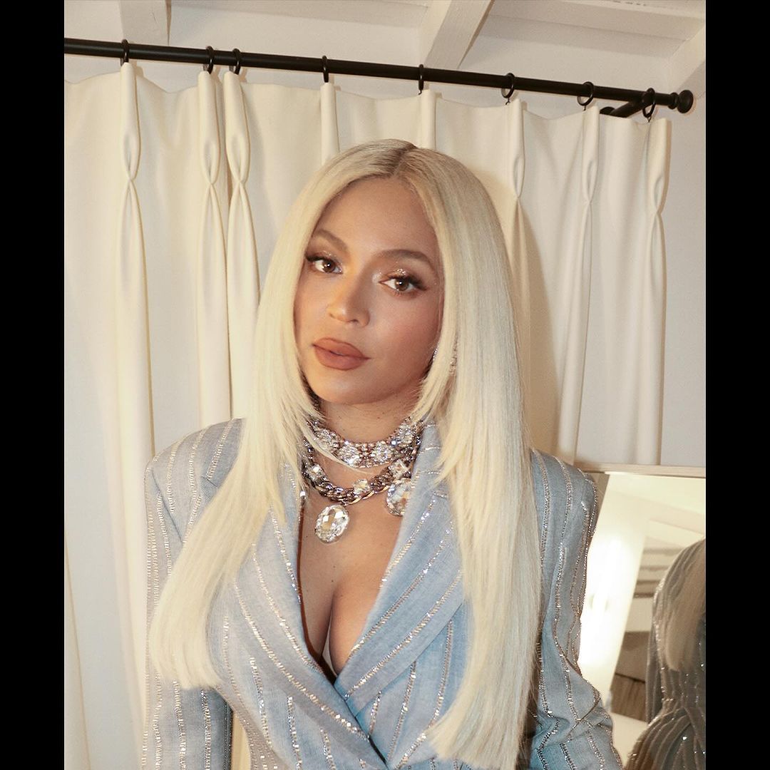 Beyoncé stuns as a platinum blonde bombshell in plunging pinstripe suit