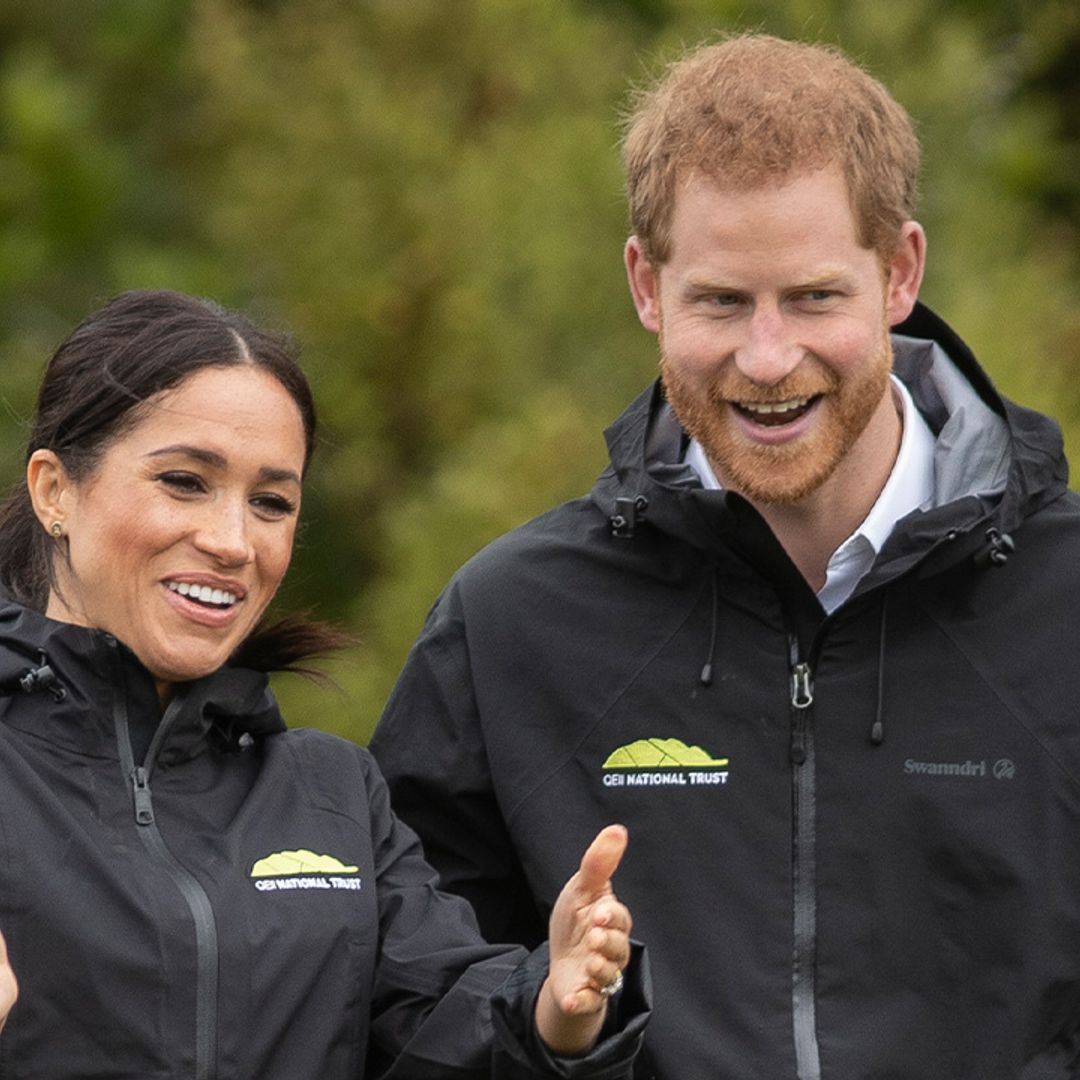 Prince Archie adorably clings to his father Prince Harry's legs in candid clip