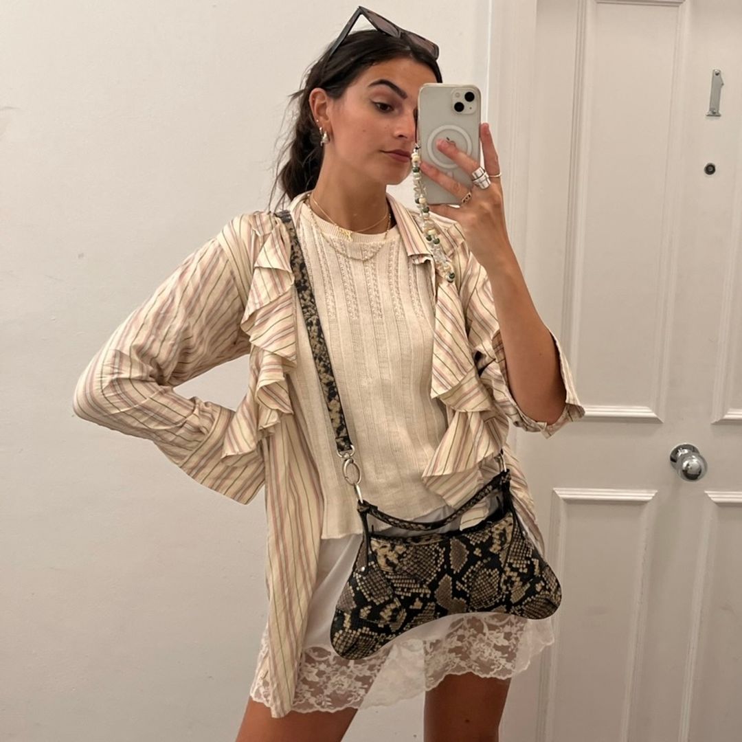 brunette girl wearing Vintage ruffled Ralph Lauren shirt, lace mini skirt, vintage sleeveless knit