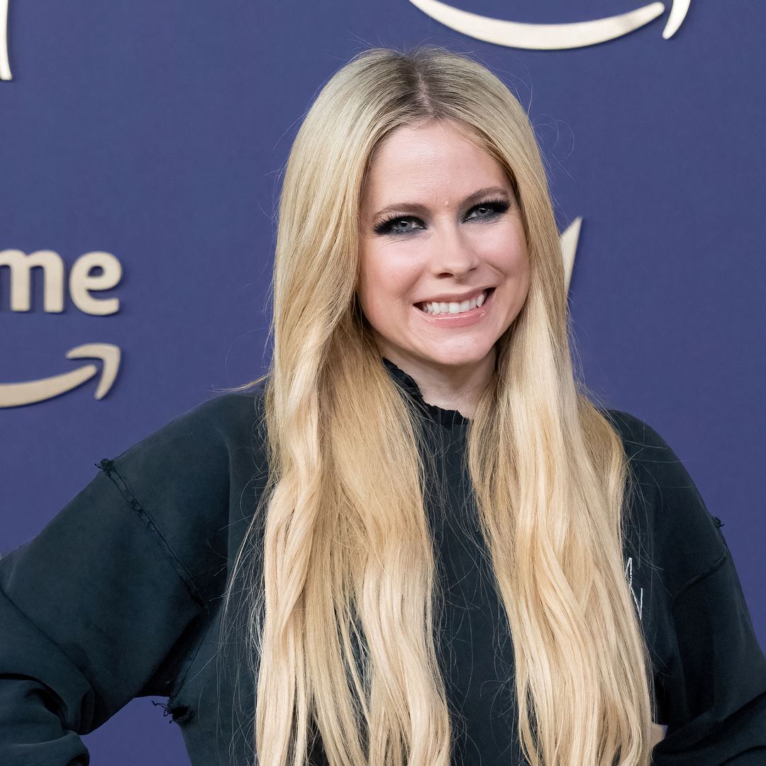 Avril Lavigne rocks out in fishnet tights and knee-high combat boots in snaps from new tour