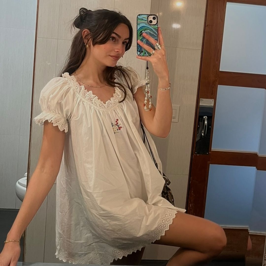 brunette girl in Dôen babydoll dress with floral embroidery