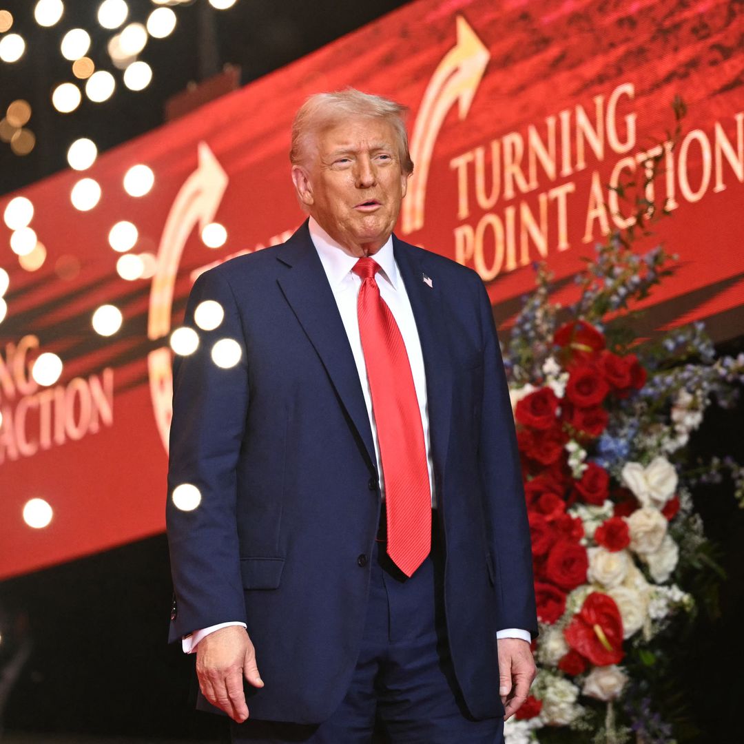 US President Donald Trump arrives on stage during the public memorial service for right-wing activist Charlie Kirk at State Farm Stadium in Glendale, Arizona, on September 21, 2025