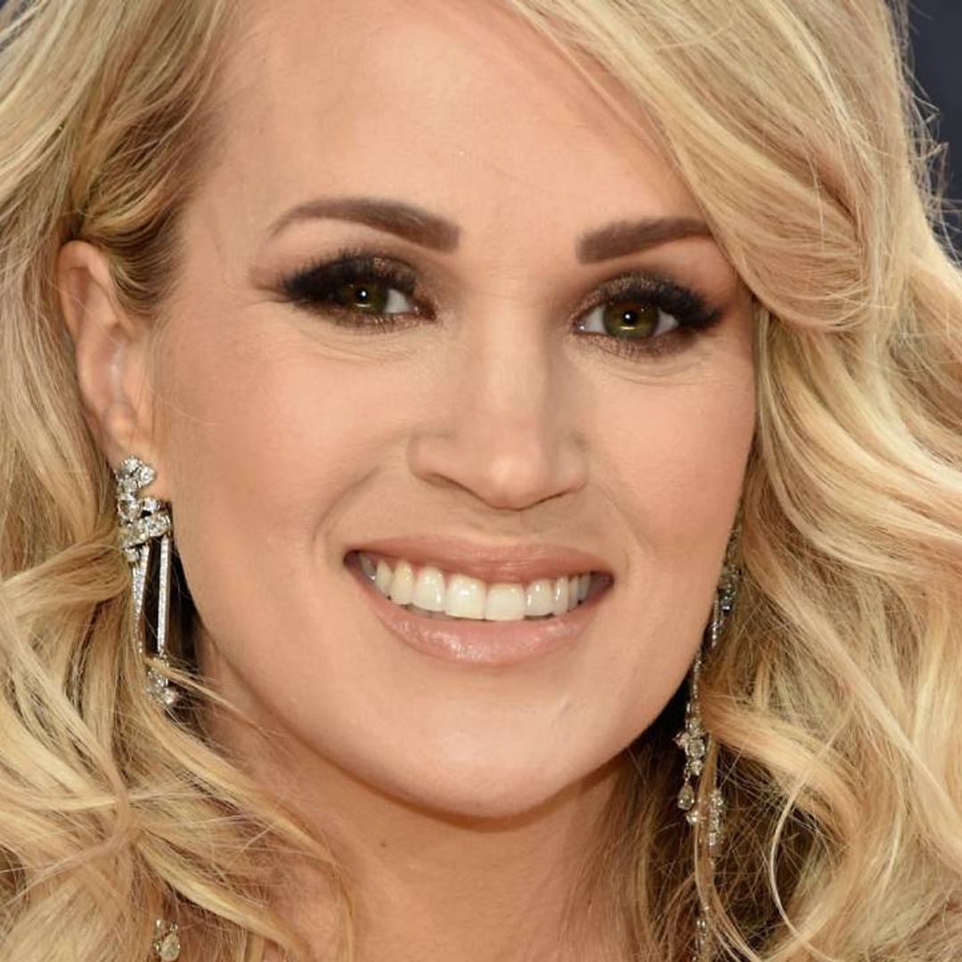 Carrie Underwood looks sensational in a metallic mini dress and thigh-high boots