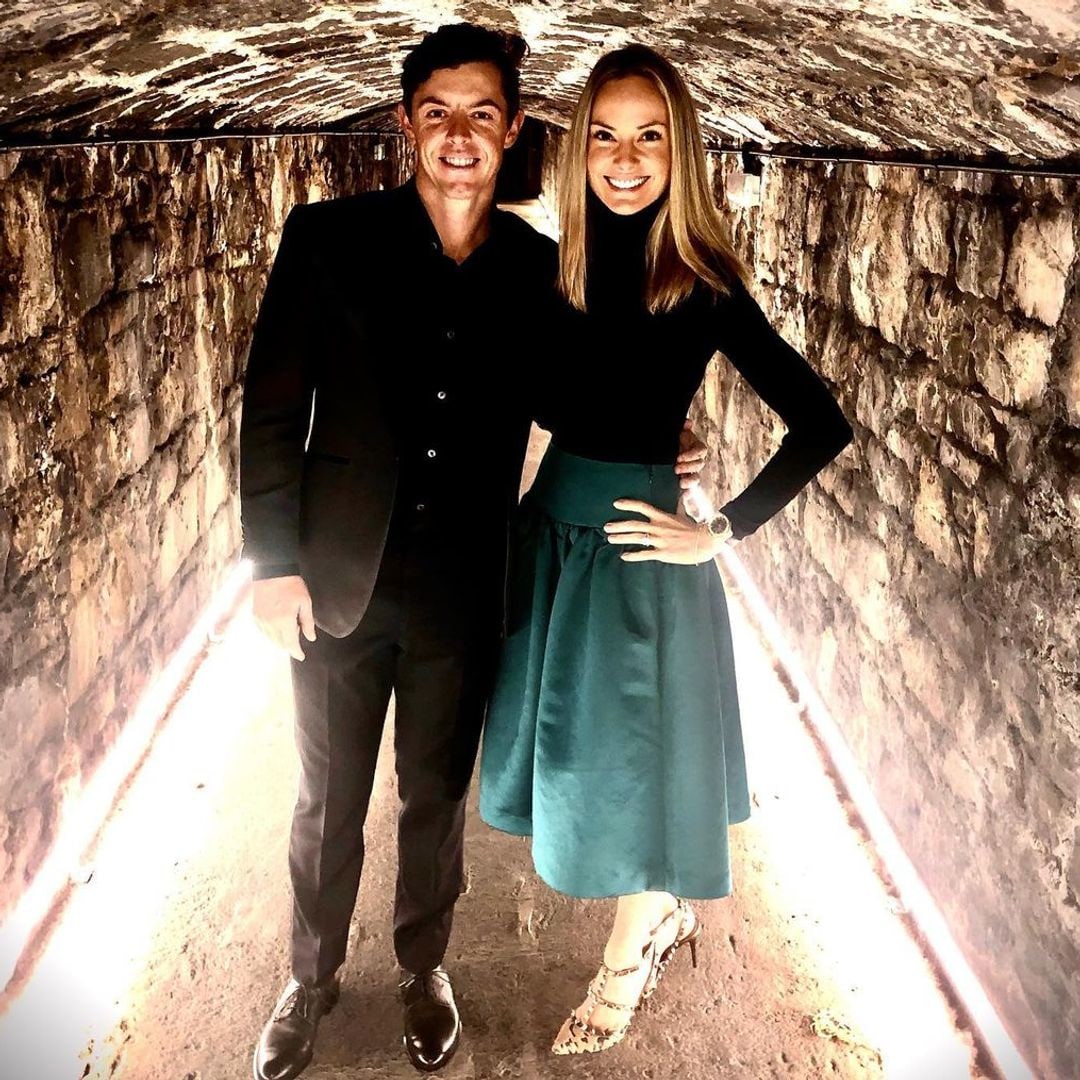 The couple smiling in an archway at Ashford Castle in 2019