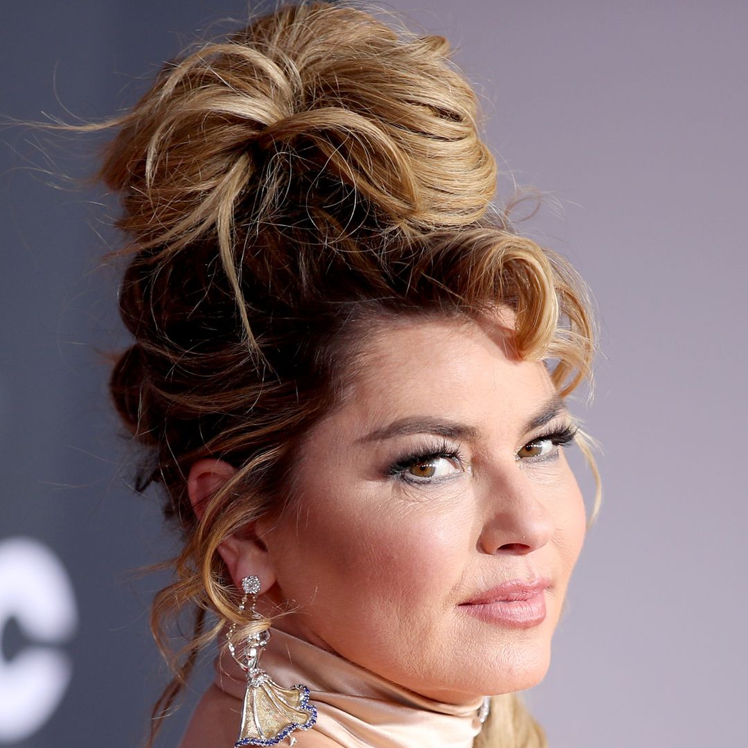 Shania Twain explores her sense of style in nothing but a hat and cowboy boots
